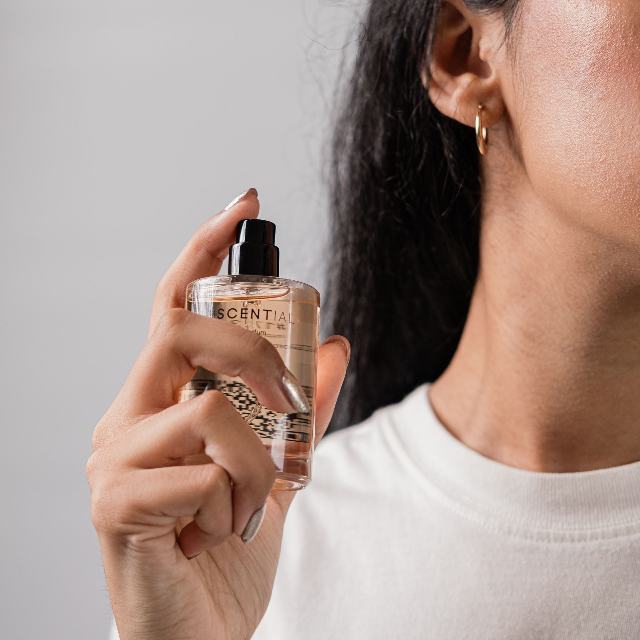 Woman spraying neck with inspired by perfume South Africa